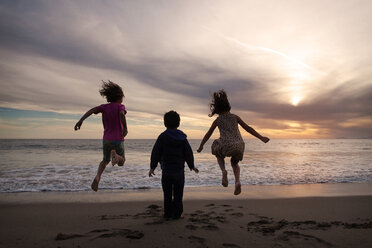 Children enjoying at shore during sunset - CAVF11676