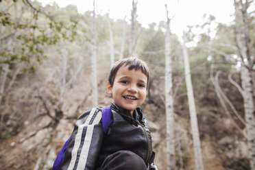 Portrait of boy standing in forest - CAVF11677