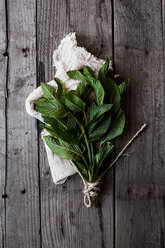 Overhead view of mint leaves bunch on wooden table - CAVF12119