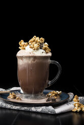 Close-up of hot chocolate with whipped cream and caramel popcorn - CAVF12203