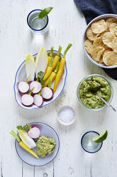 Overhead view of guacamole and vegetables on table - CAVF12328