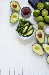 High angle view of avocados, lemons and chilies on table - CAVF12329