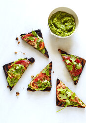 Overhead view of open faced sandwiches and chutney over white background - CAVF12347