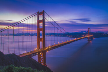 Light trails on Golden Gate Bridge against blue sky at dusk - CAVF12579