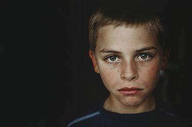 Portrait of boy in dark room - CAVF12590