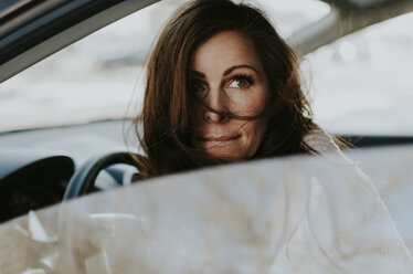 Woman looking away while sitting in car - CAVF12591