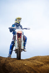 Low angle view of woman riding motorcycle against sky - CAVF12808