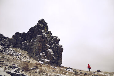 Distant view of hiker walking on mountain against clear sky - CAVF12984