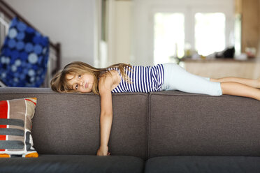 Portrait of bored girl lying on sofa at home - CAVF13675