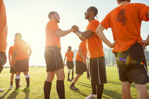 Happy soccer team on field during sunny day - CAVF13689