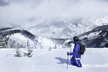 Skier walking on snow covered mountain against sky - CAVF14149