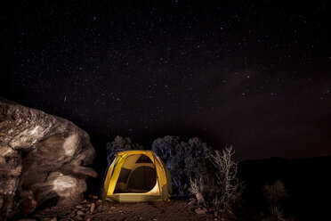 Tent by rock on mountain against starry sky - CAVF14153