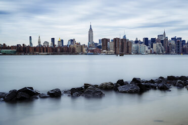 River by cityscape against cloudy sky - CAVF14201