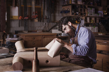 Carpenter making wooden furniture at workshop - CAVF14376