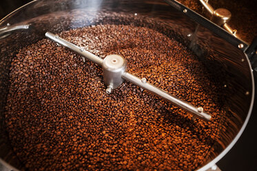 High angle view of coffee beans in coffee roaster - CAVF14651