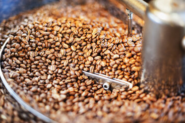 Close up of coffee beans in coffee roaster - CAVF14652