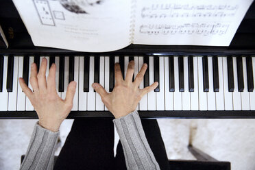 Overhead view of senior woman playing piano at home - CAVF14974