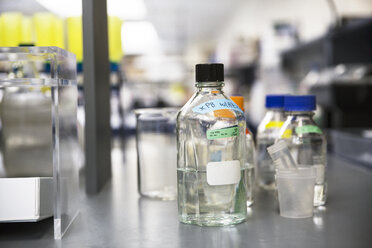 Close-up of sample bottles on counter in laboratory - CAVF14993