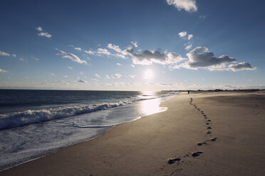 Footprints at beach against sky on sunny day - CAVF15105