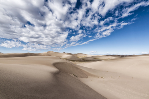 Desert landscape against cloudy sky stock photo