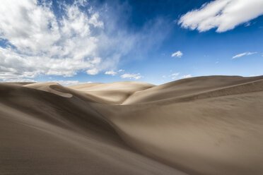 Scenic view of sand dunes against blue sky - CAVF15155