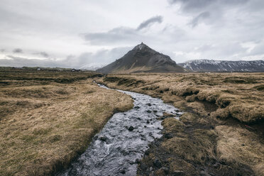 Stream amidst field against sky - CAVF15174