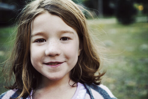 Portrait of smiling girl in park - CAVF15190