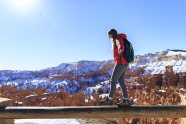 Weiblicher Wanderer, der im Bryce Canyon National Park gegen einen klaren blauen Himmel auf einem Waldstück läuft - CAVF15331