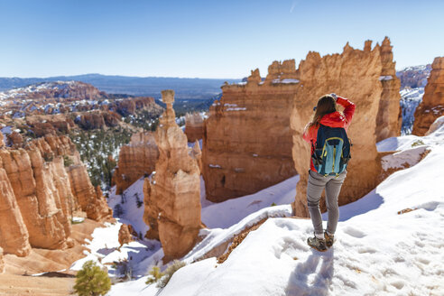 Rear view of hiker standing on snow covered mountain at Bryce Canyon National Park - CAVF15333