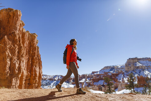 Hiker walking on mountain against clear sky at Bryce Canyon National Park during winter - CAVF15336