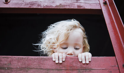 Cute girl looking away from tree house - CAVF15360