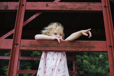 Cute girl looking away while standing in tree house - CAVF15361