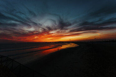 Scenic view of silhouette beach against cloudy sky during sunset - CAVF15416