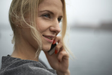 Close-up of businesswoman talking on mobile phone - CAVF15524