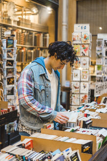 Young man in bookshop - AFVF00352