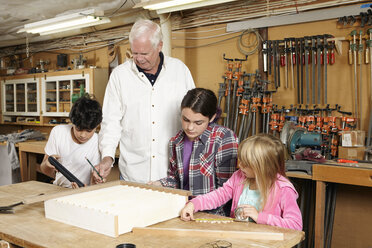 Carpenter teaching students in workshop - CAVF16018