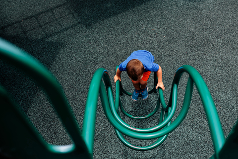 High angle view of boy playing on outdoor play equipment stock photo