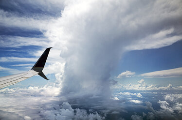 Cropped image of airplane flying in cloudy sky - CAVF16152