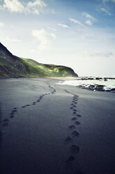 Footprints on beach against sky - CAVF16246