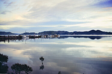 Scenic view of lake and mountains against cloudy sky - CAVF16690