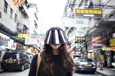 Portrait of female tourist wearing face visor on Hong Kong Street stock photo