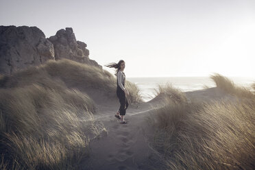 Portrait of woman standing at beach against clear sky - CAVF16864