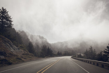 Empty country road during foggy weather - CAVF16873