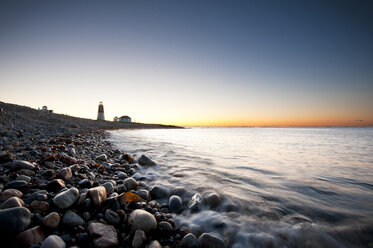 Pebbles at shore against sky during sunset - CAVF17020