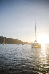 Sailboats sailing in sea against sky during sunrise - CAVF17024