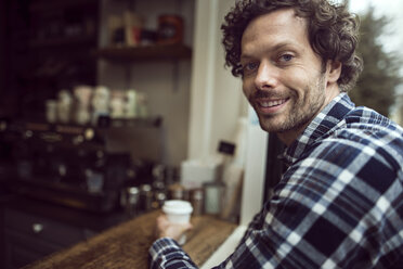 Side view portrait of happy man sitting at cafe - CAVF17322