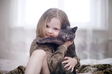 Portrait of girl embracing cat - CAVF17597