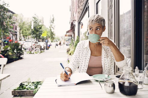 Frau trinkt Kaffee in einem Straßencafé - CAVF17686