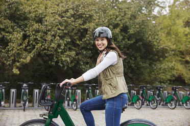 Portrait of smiling woman riding bicycle - CAVF17749