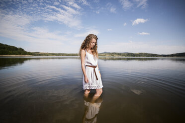Woman standing in lake against sky - CAVF17827